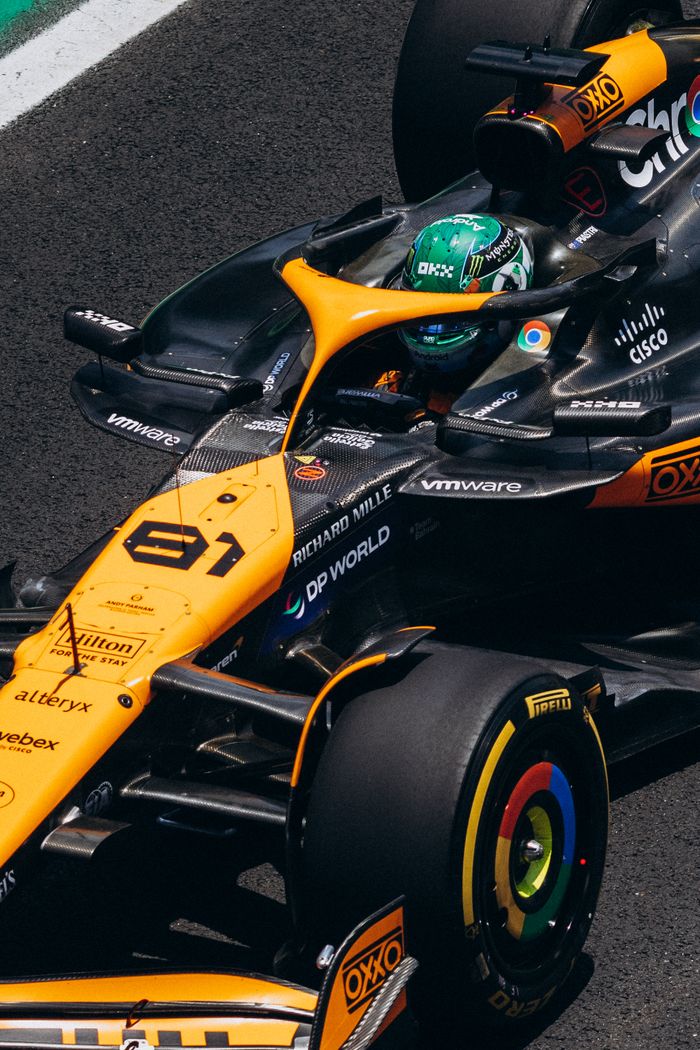 Close-up view of a Formula 1 race car in action on the track, highlighting vibrant design.