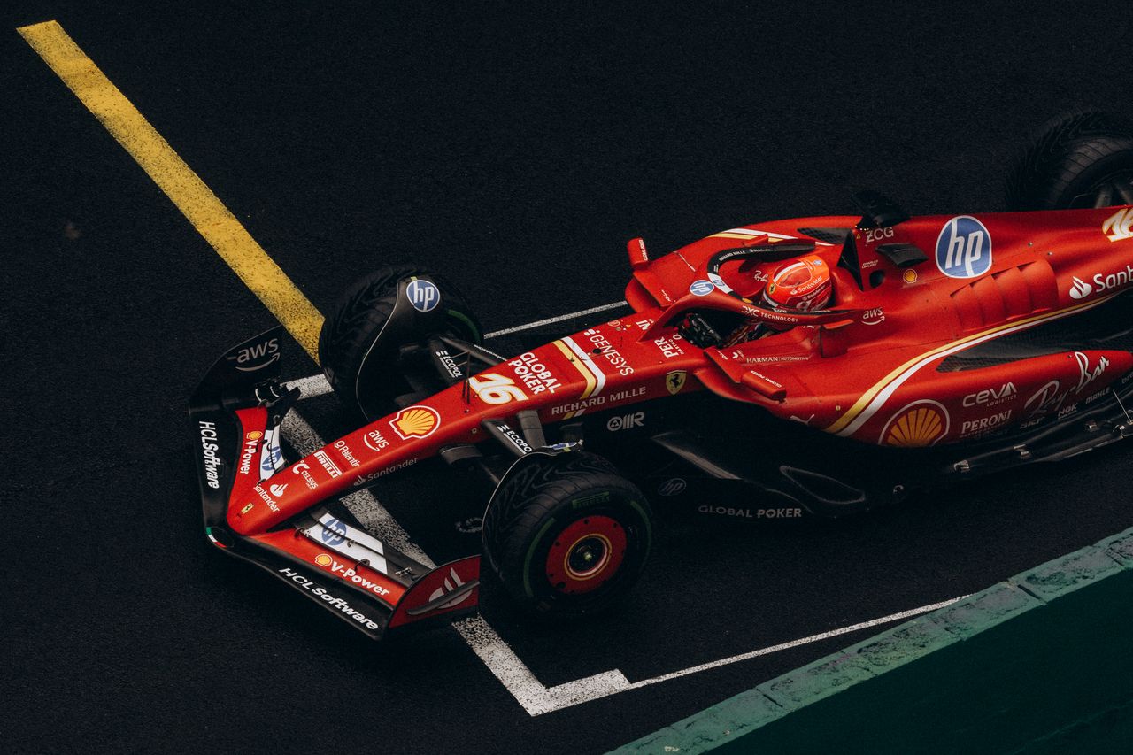 ours-journey Dynamic shot of a red Formula One car racing on a track, showcasing speed and precision.